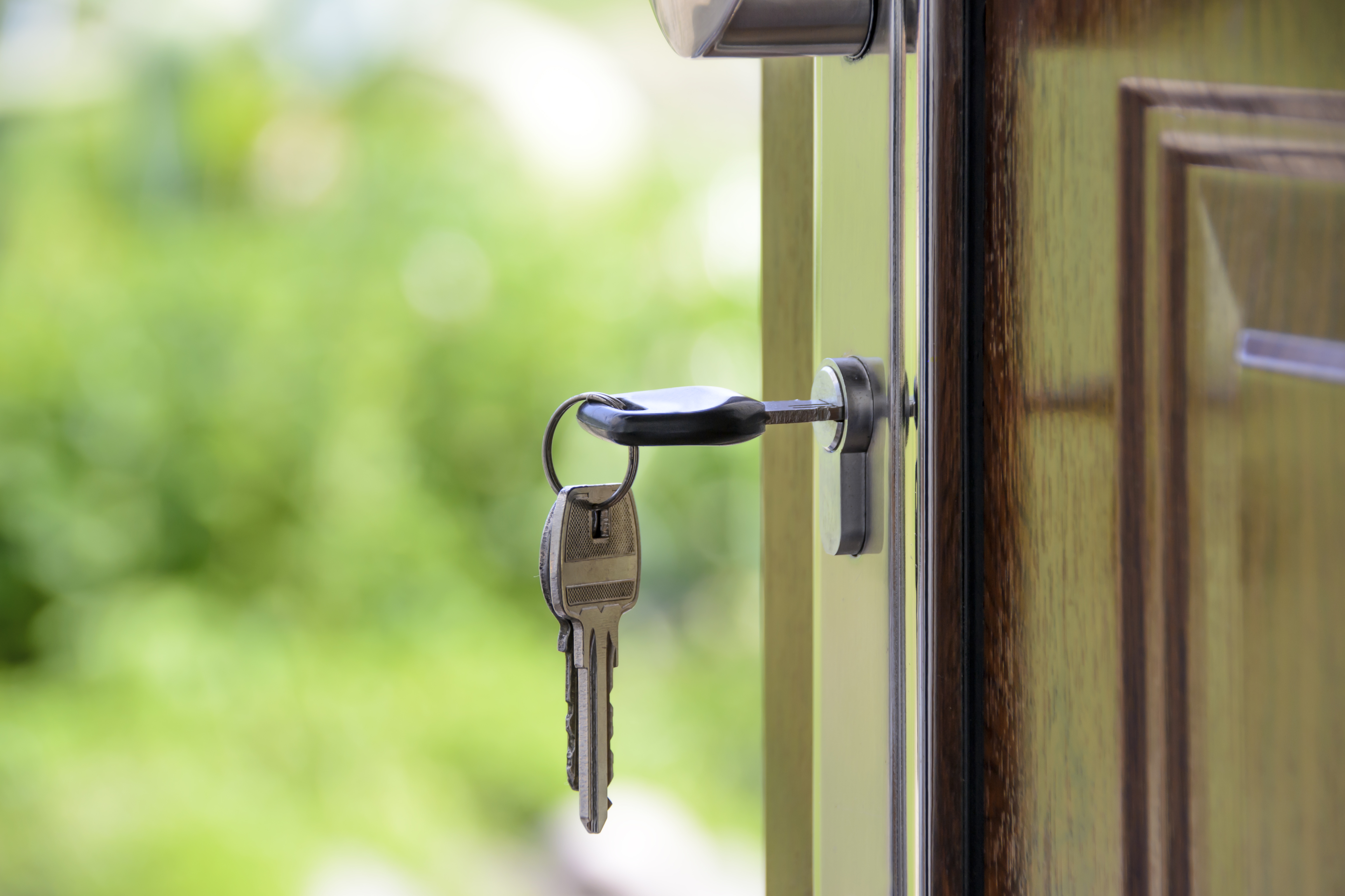 House keys in a front door, a reminder to plan possession during home buying negotiations